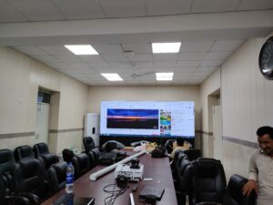 A conference room with a large LCD Video Wall screen displayed for presentations and meetings. Installed By EziSol.