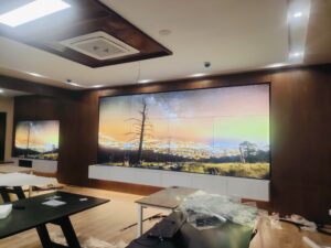 EziSol installed a complete solution of 3x3 indoor LCD Video Wall by using 55” video wall panels showing sunset view from a hill, the screen is hanging with wall using aluminium wall mounts. 