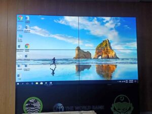 LCD video wall, with an image of a person running on a beach as the wallpaper, icons arranged on the left, and a taskbar at the bottom, Installed by EziSol.