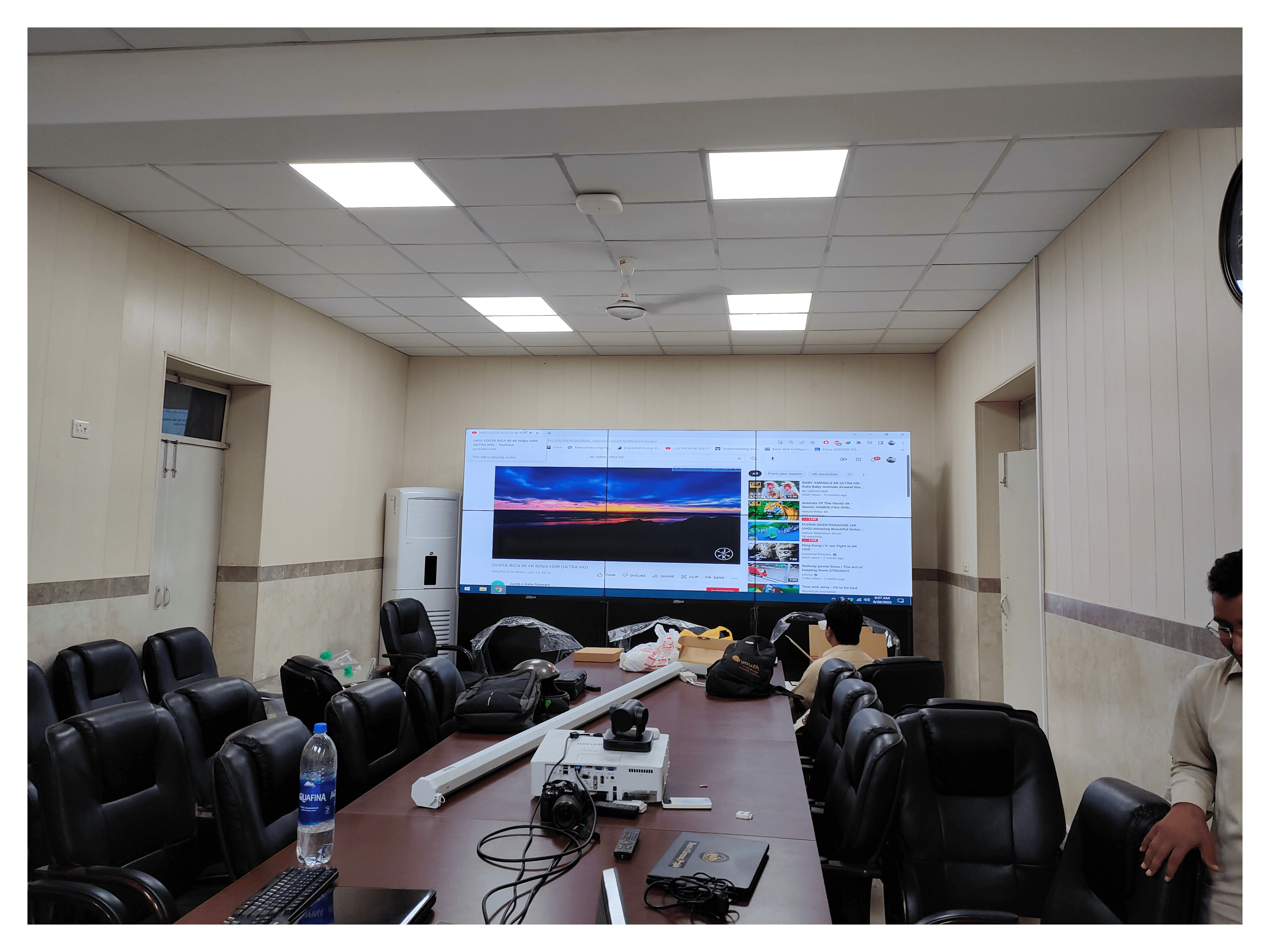 A conference room with a large LCD Video Wall screen displayed for presentations and meetings. Installed By EziSol.